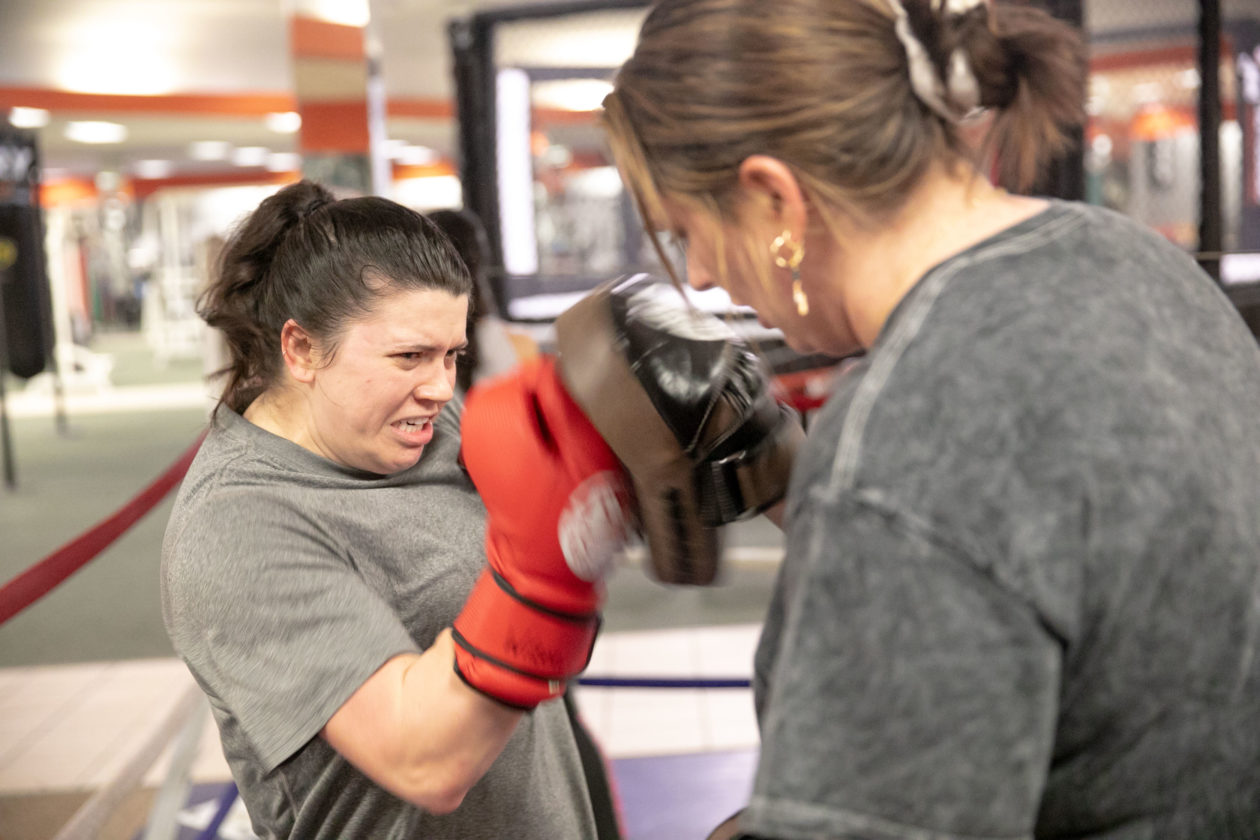 Female Boxer hitting pads