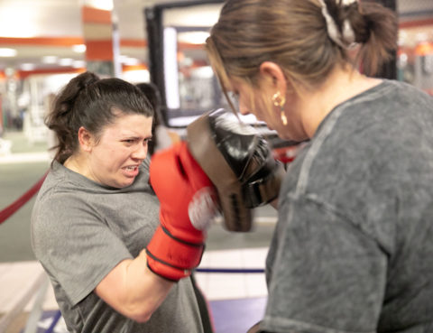 Female Boxer hitting pads